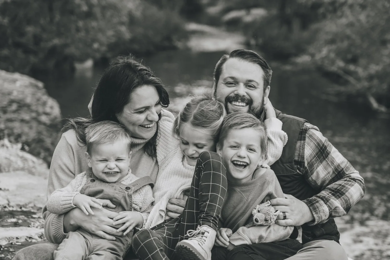 Reaghen and Jackson Bailey laughing with their three children